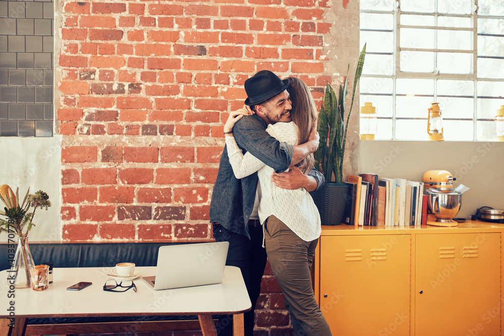 Young couple embracing each other at a coffee