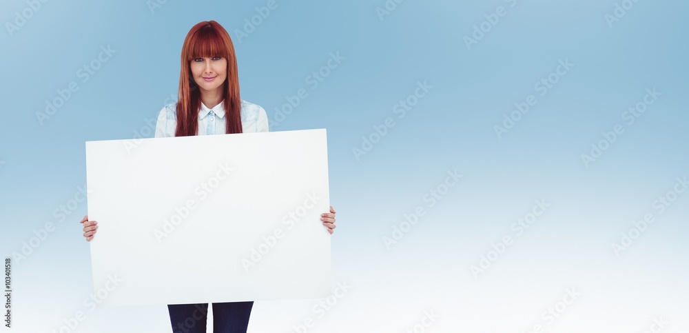 Composite image of attractive hipster woman holding white card