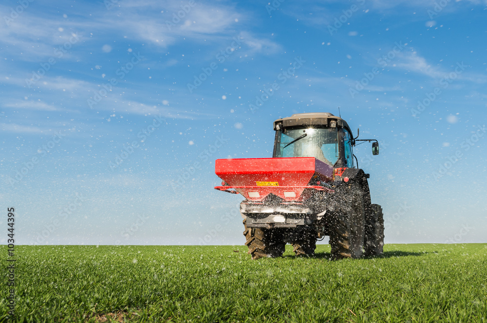  tractor fertilizing in field