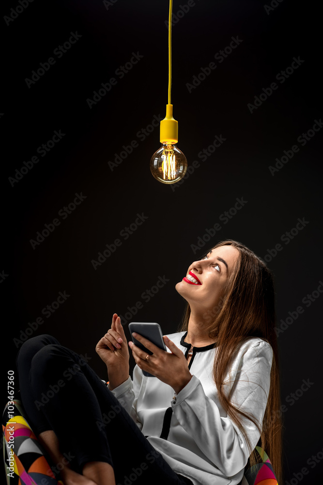 Woman with smart phone having idea