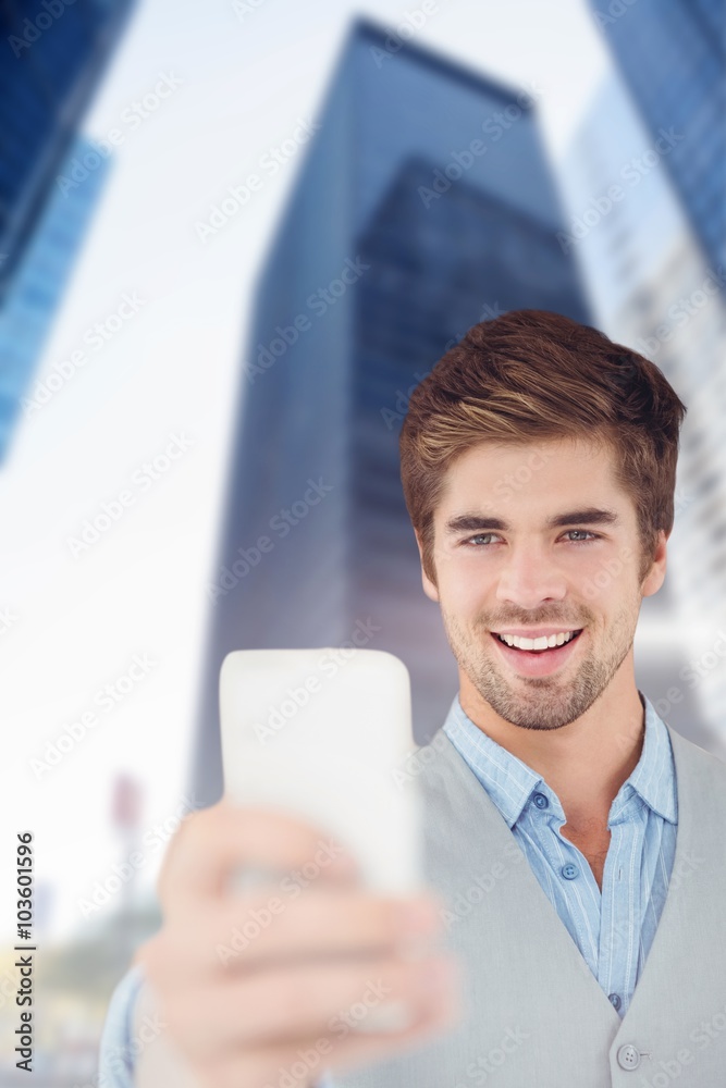 Composite image of happy businessman taking selfie