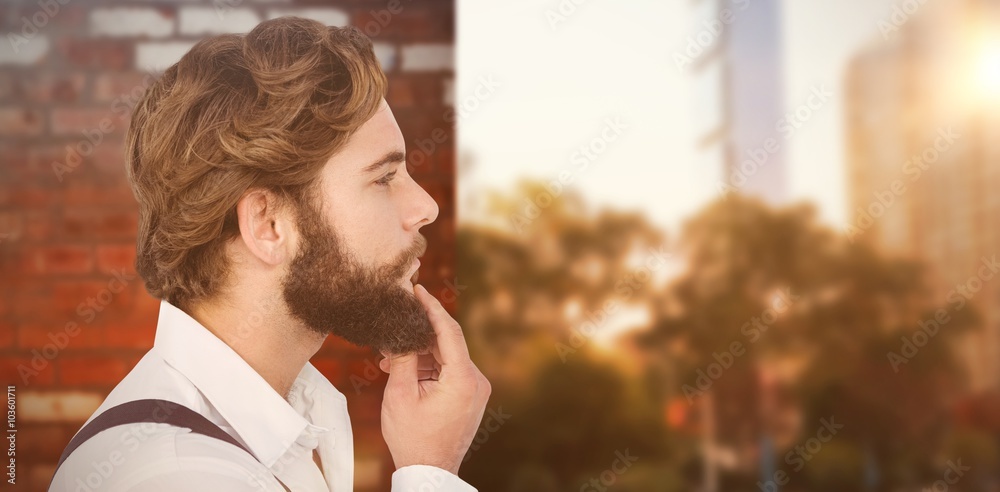 Composite image of profile view of hipster touching beard