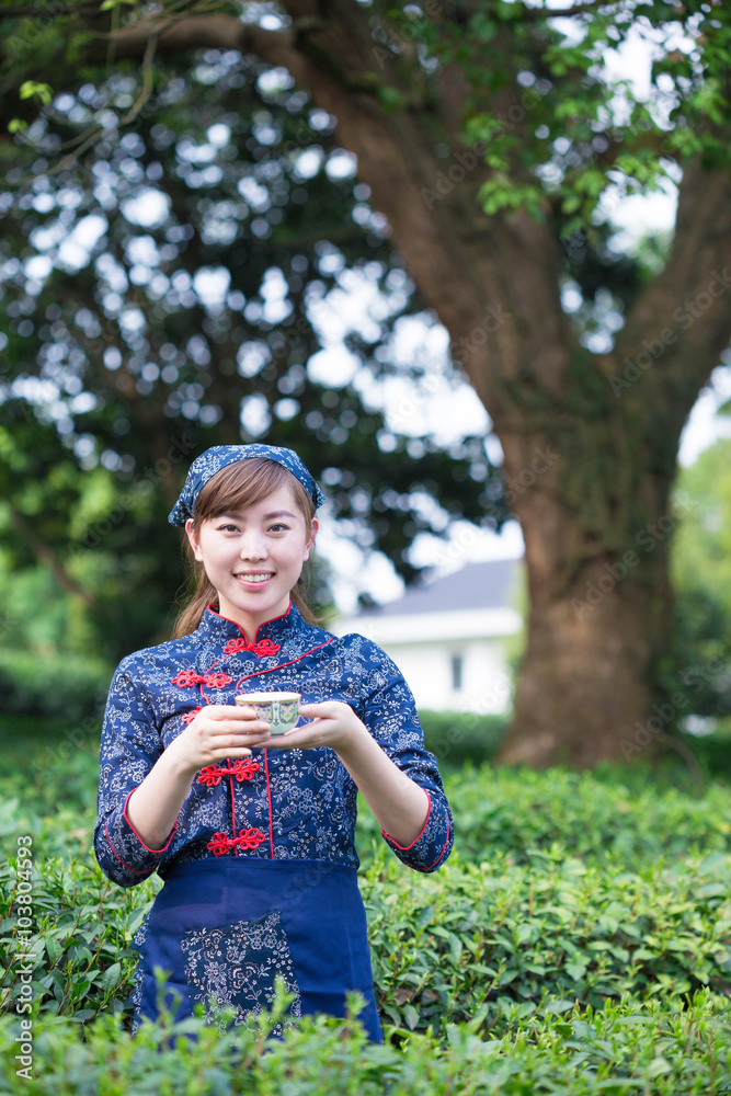 beautiful Asian girl works in green tea plantation