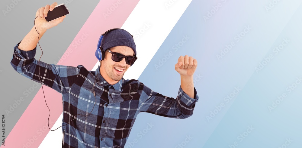 Composite image of happy hipster wearing headphones enjoying music