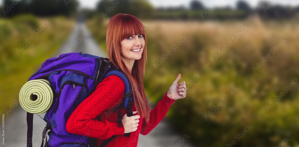 Composite image of smiling hipster woman with a travel bag