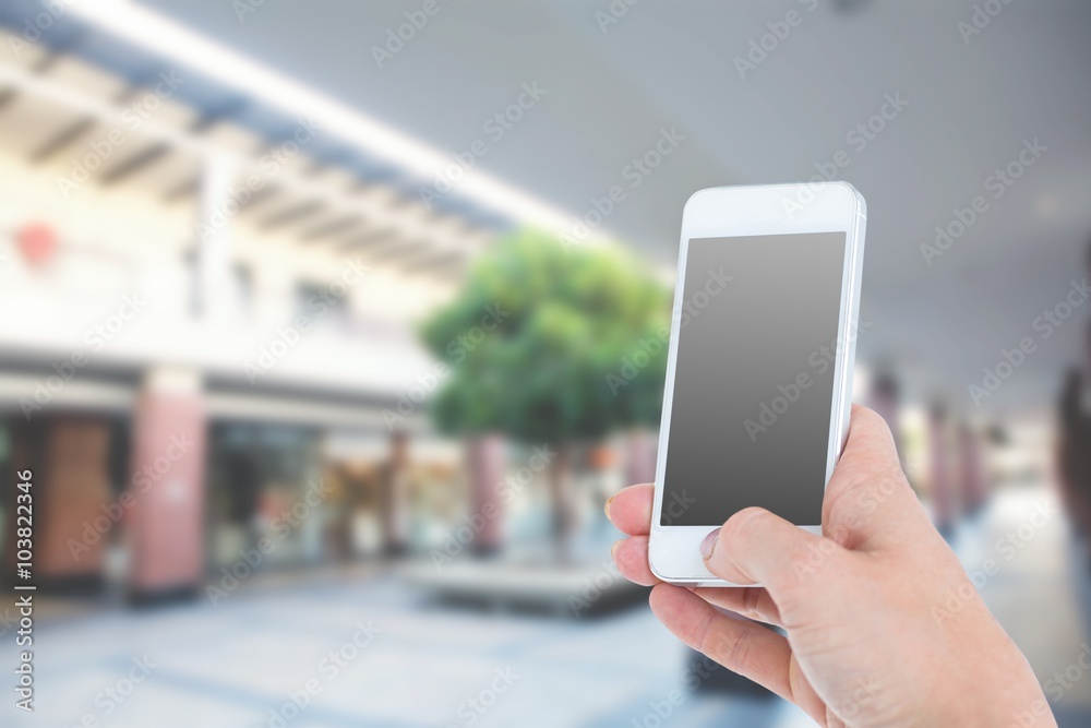 Composite image of woman showing smartphone 