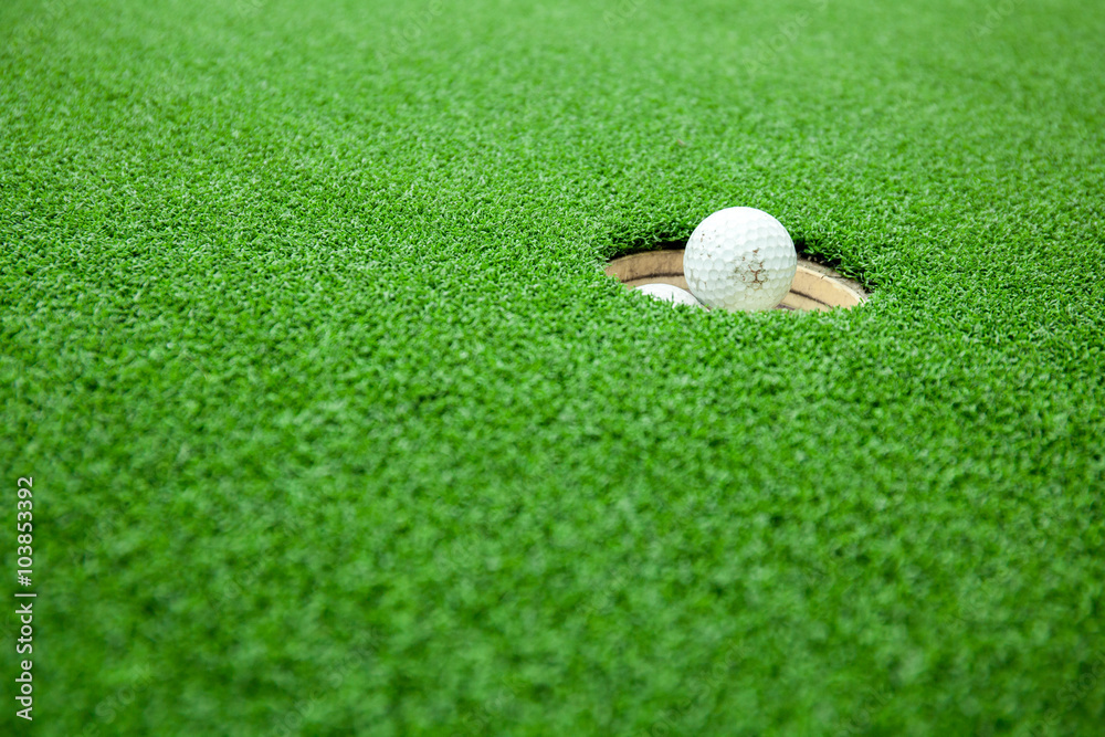 Top view of golf balls stacked up in green field