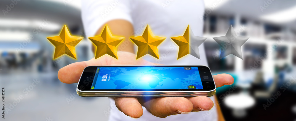 Businessman rating stars with his mobile phone