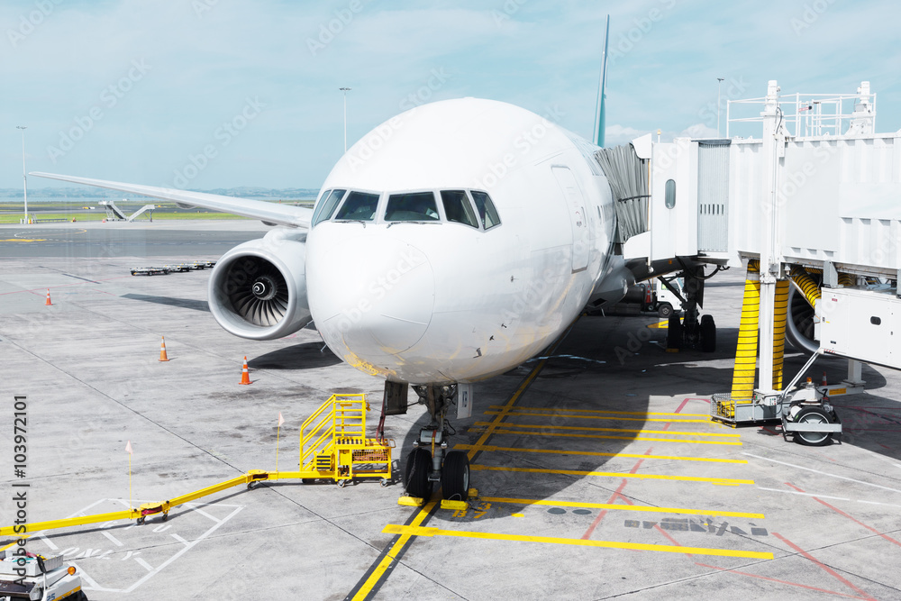 white airplane in apron in cloudy sky