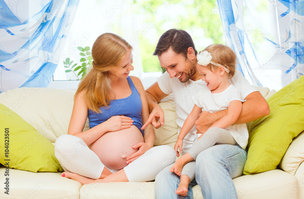 happy family. pregnant mother, father, and child daughter at hom