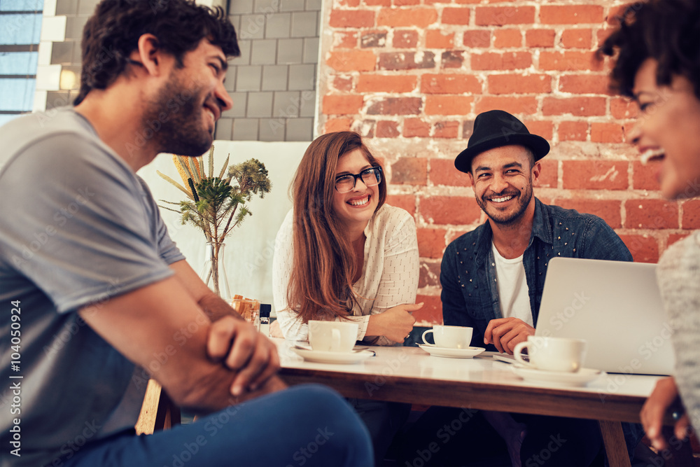 Group of young friends hanging out at a cafe