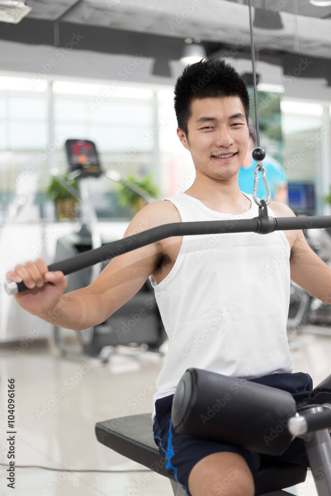 young man working out in modern gym