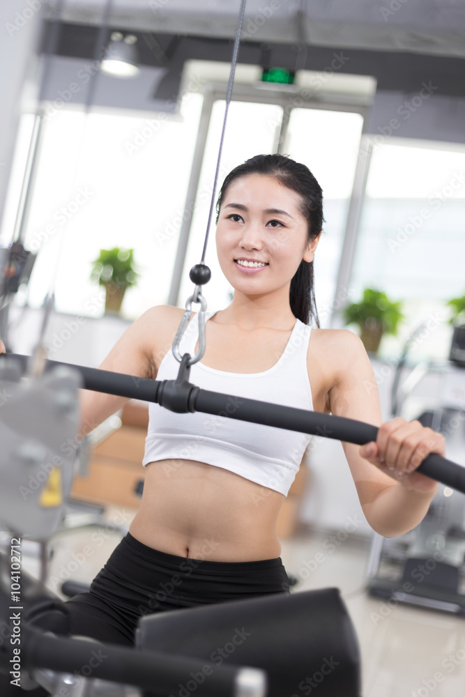 beautiful girl working out in modern gym