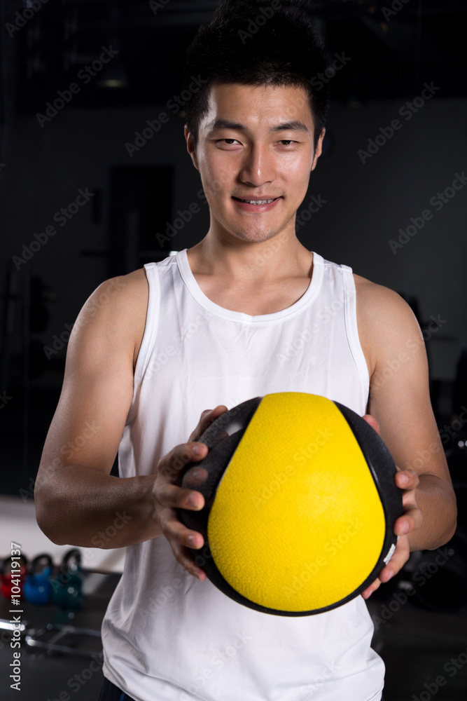 handsome young man working out in modern gym