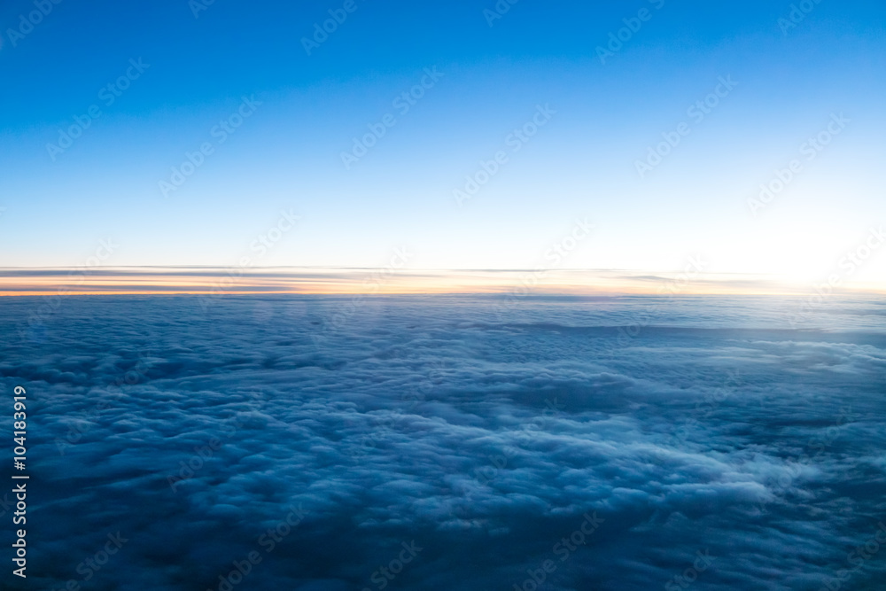 Beautiful dark sunset above clouds