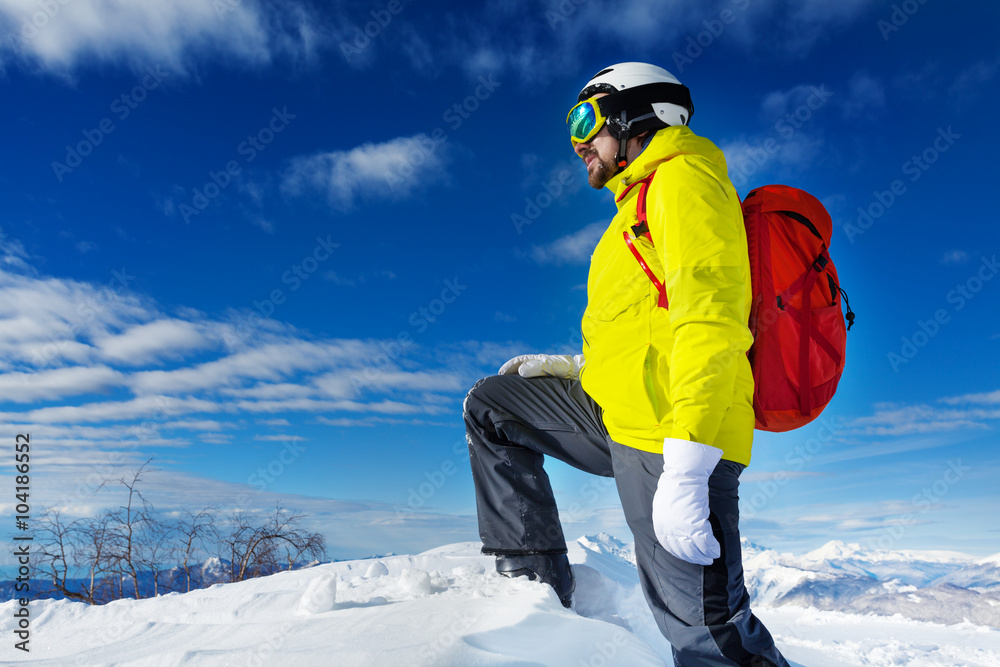 Skier man stand on top of the mountain 