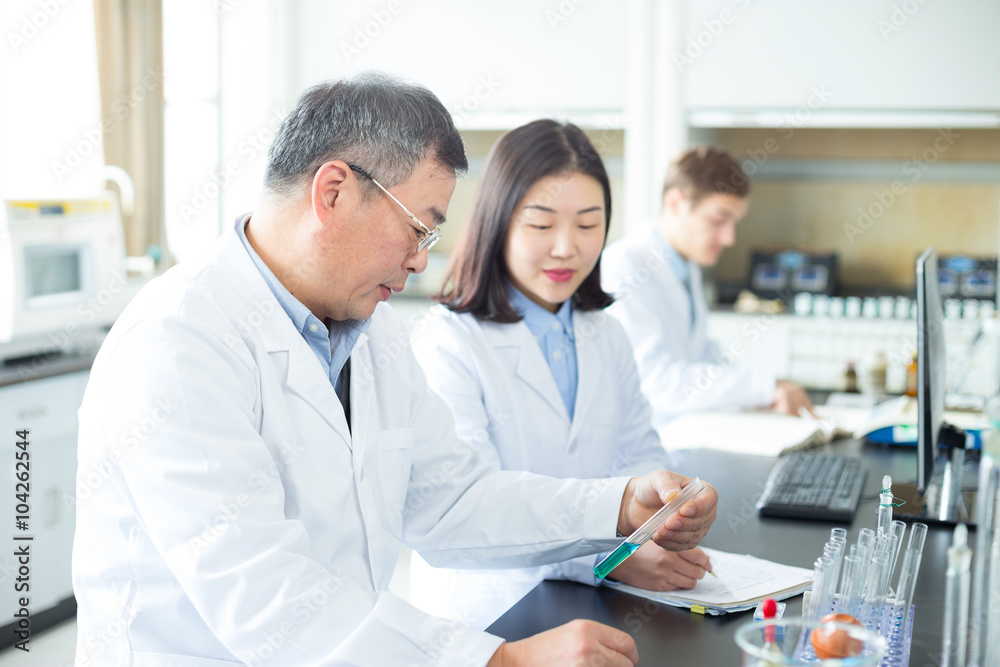 people doing chemical experiment in modern lab