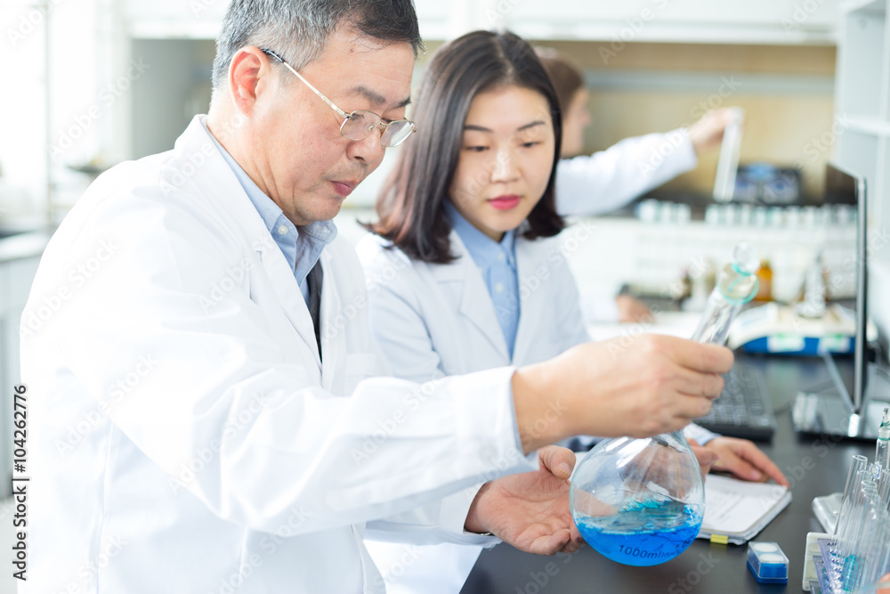 people doing chemical experiment in modern lab