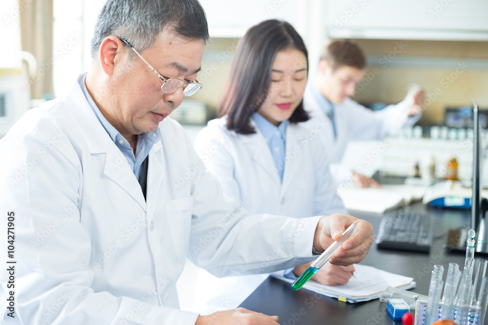 people doing chemical experiment in modern lab