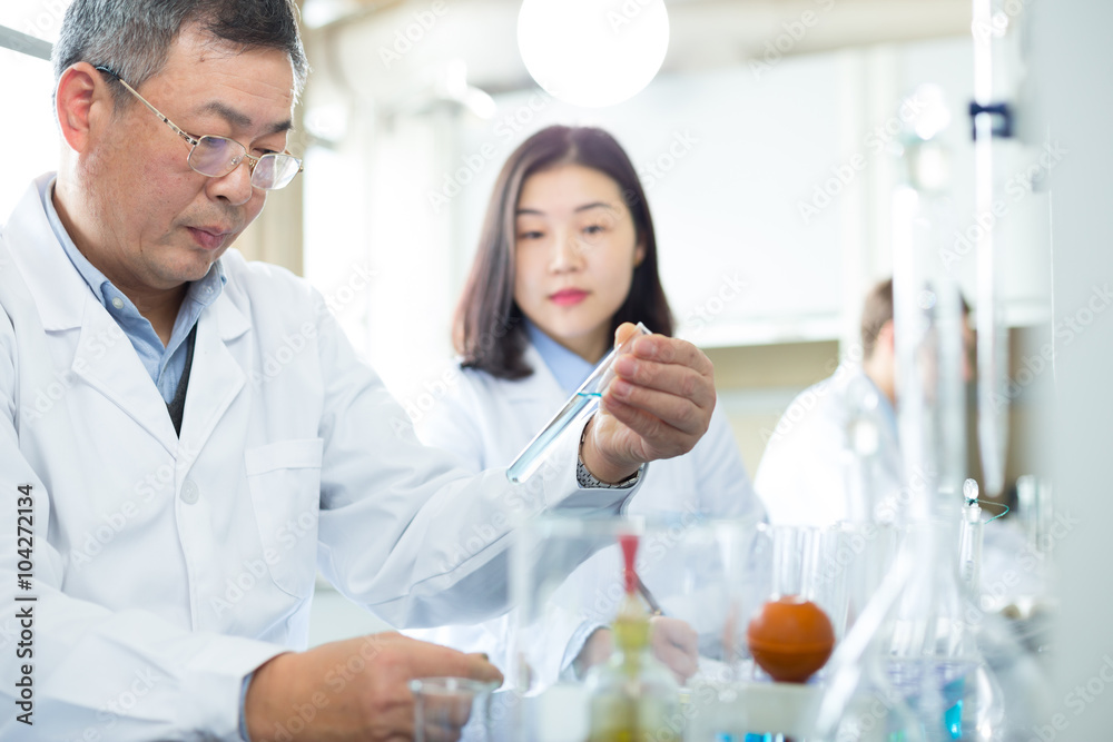 people doing chemical experiment in modern lab