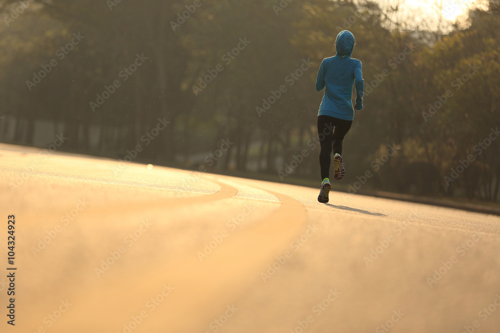 young fitness woman runner athlete running at road