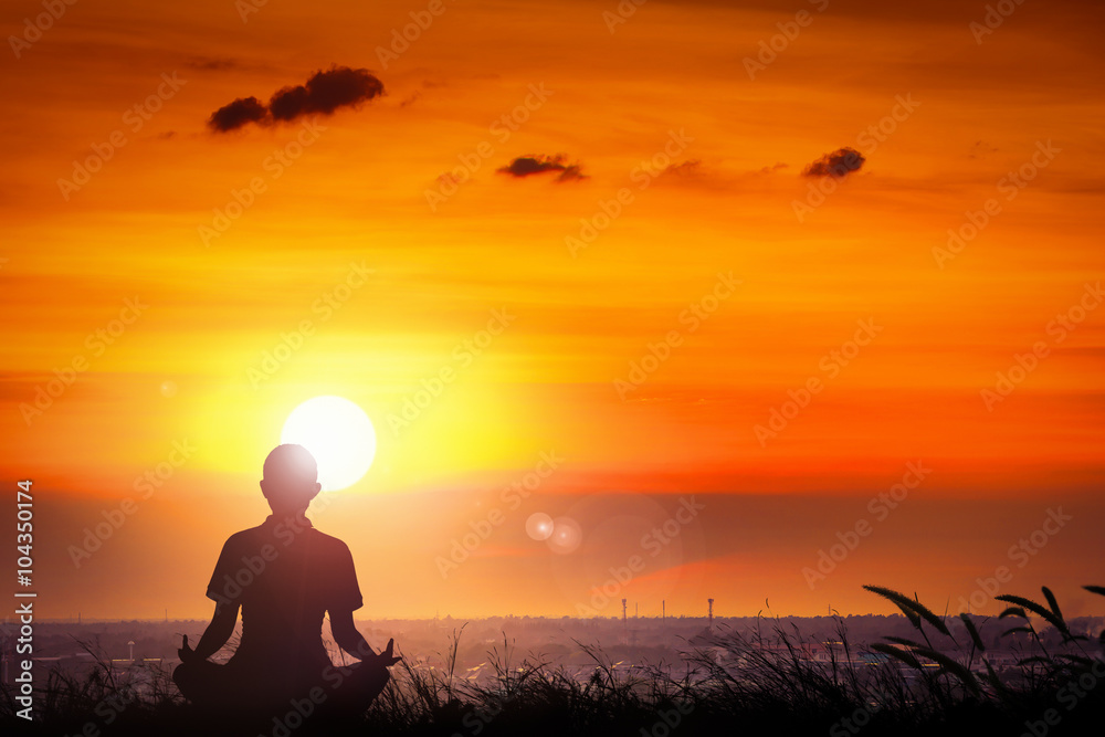 Silhouette of young women yoga at the sunset on hill.