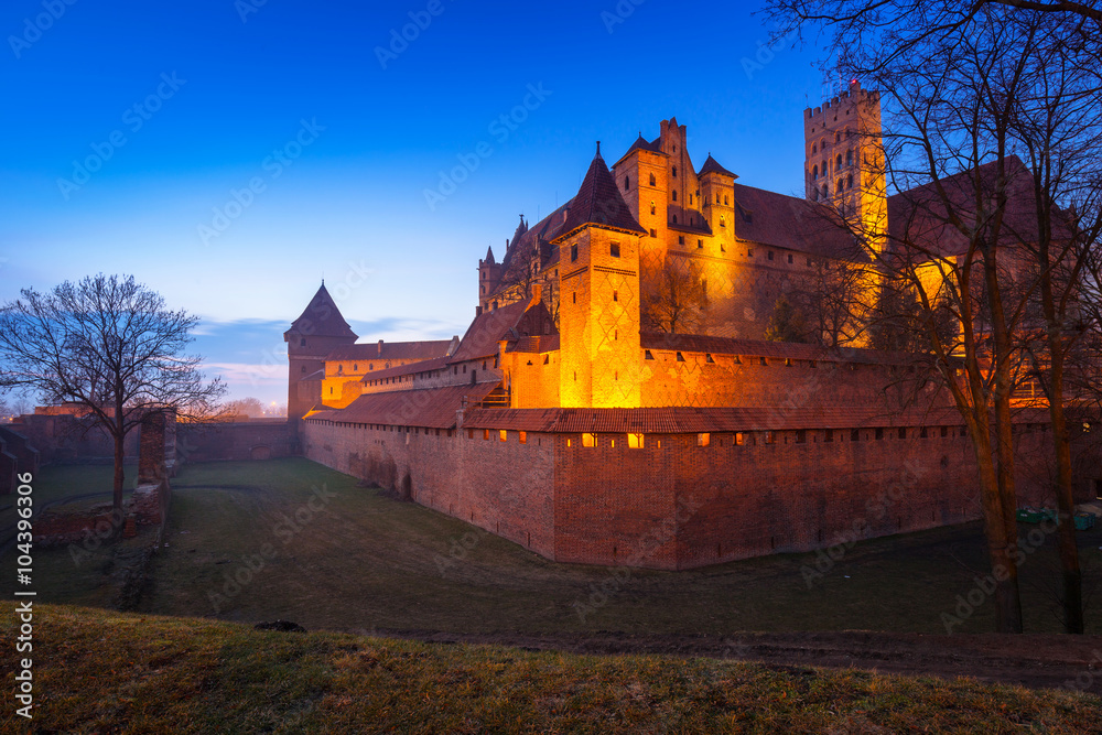 The Castle of the Teutonic Order in Malbork at dusk, Poland