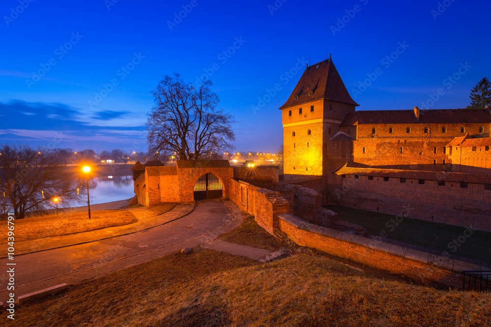 The Castle of the Teutonic Order in Malbork at dusk, Poland