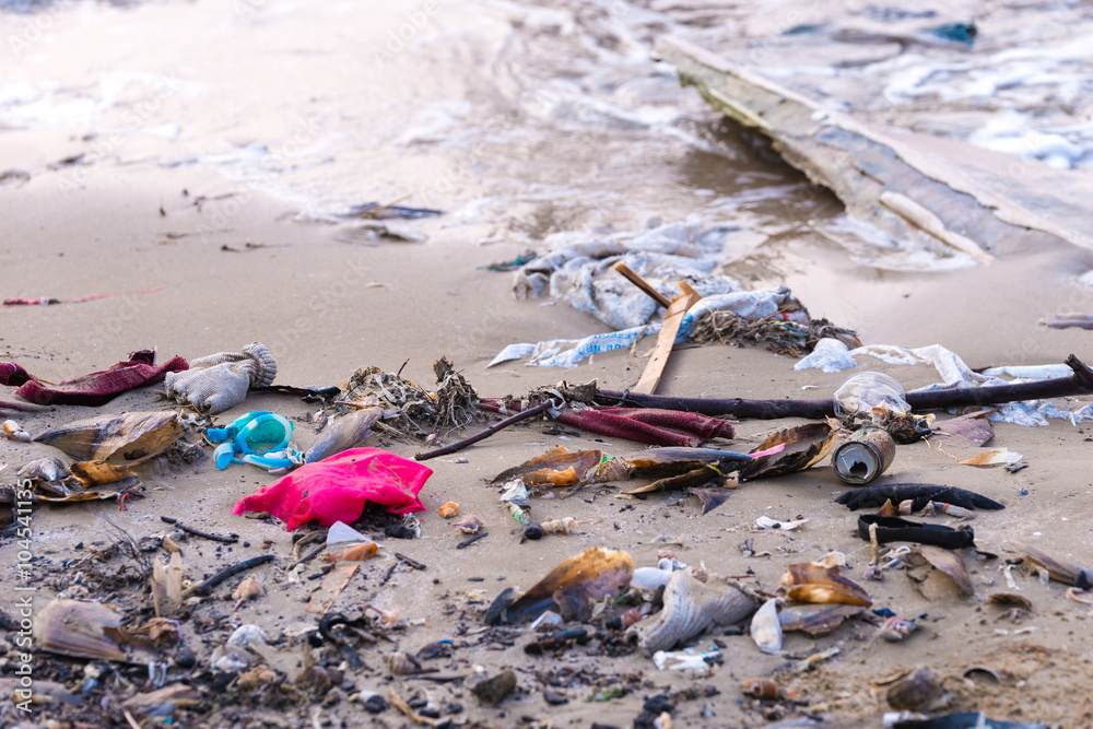 Beach pollution. Plastic bottles and other trash on sea beach