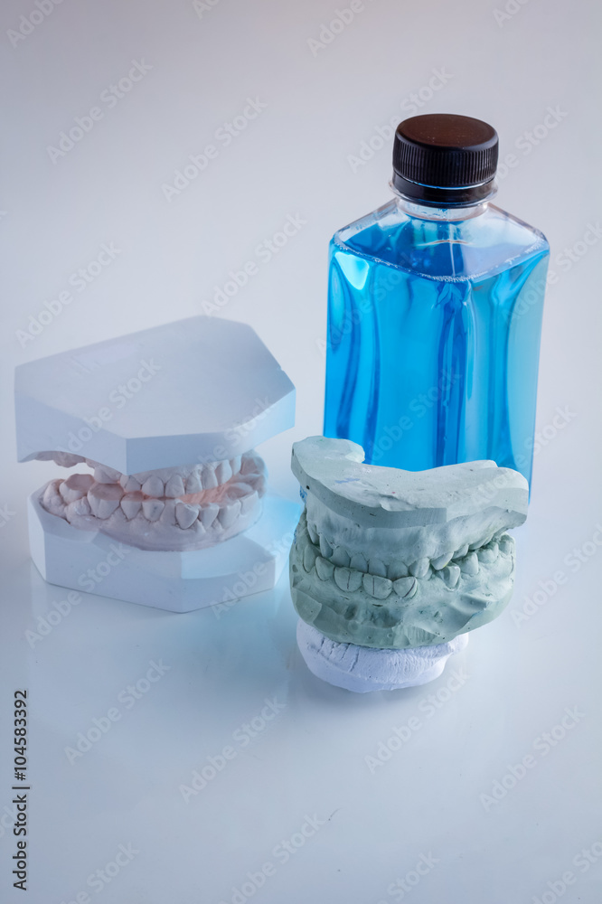 set of acrylic denture with mouth wash