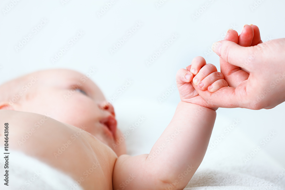 concept of parental love. baby hand holding  finger of mother