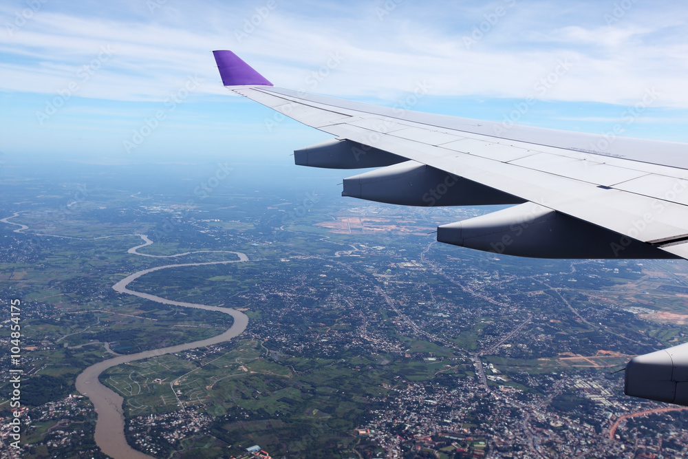 airplane wing with landscape background