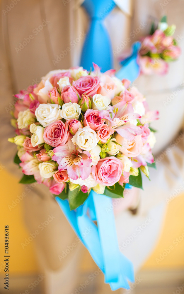 male hand giving bouquet of white roses