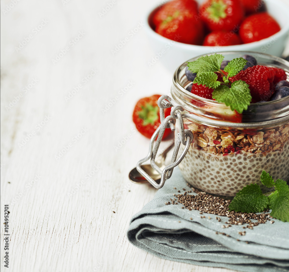 Chia seeds vanilla pudding and berries on wooden rustic backgrou