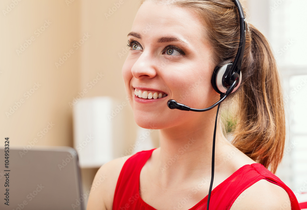 Happy young woman talking on her laptop