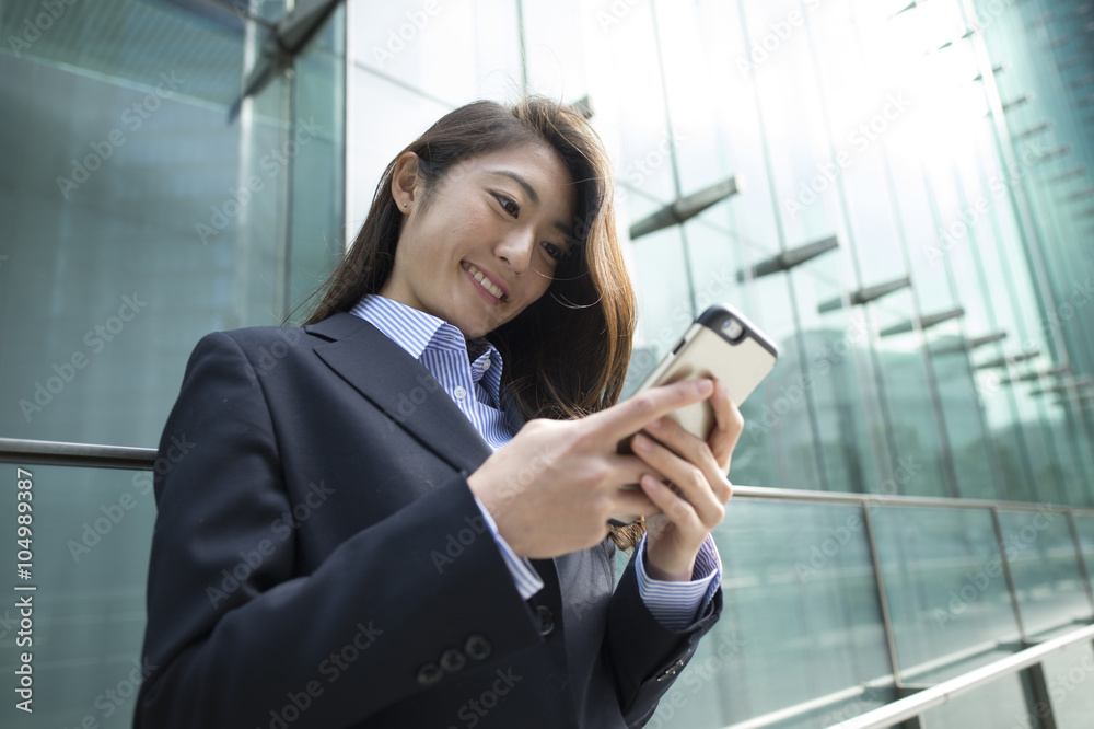 Businesswoman is looking at the smartphone