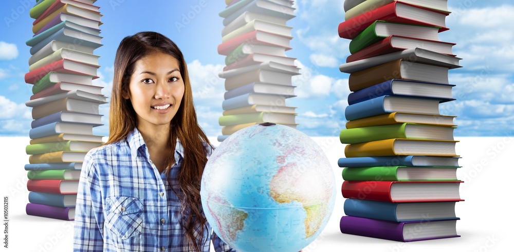 Composite image of smiling asian woman holding a globe