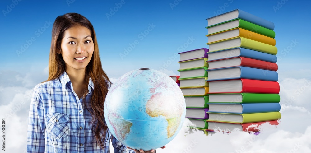 Composite image of smiling asian woman holding a globe