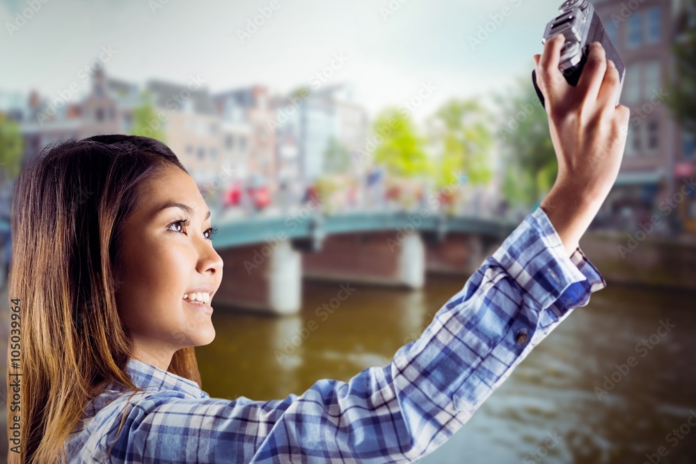 Composite image of smiling asian woman taking picture