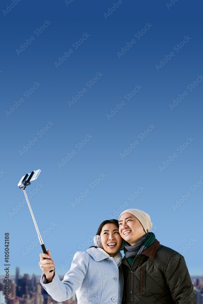 Composite image of smiling couple taking selfie