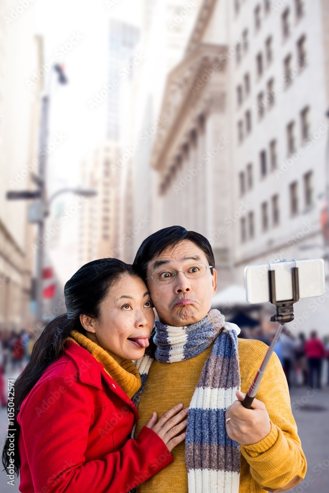 Composite image of older asian couple on balcony taking selfie