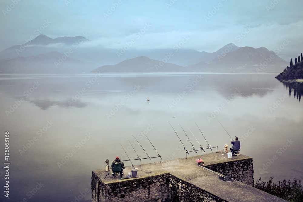 Fishermen angling at big lake