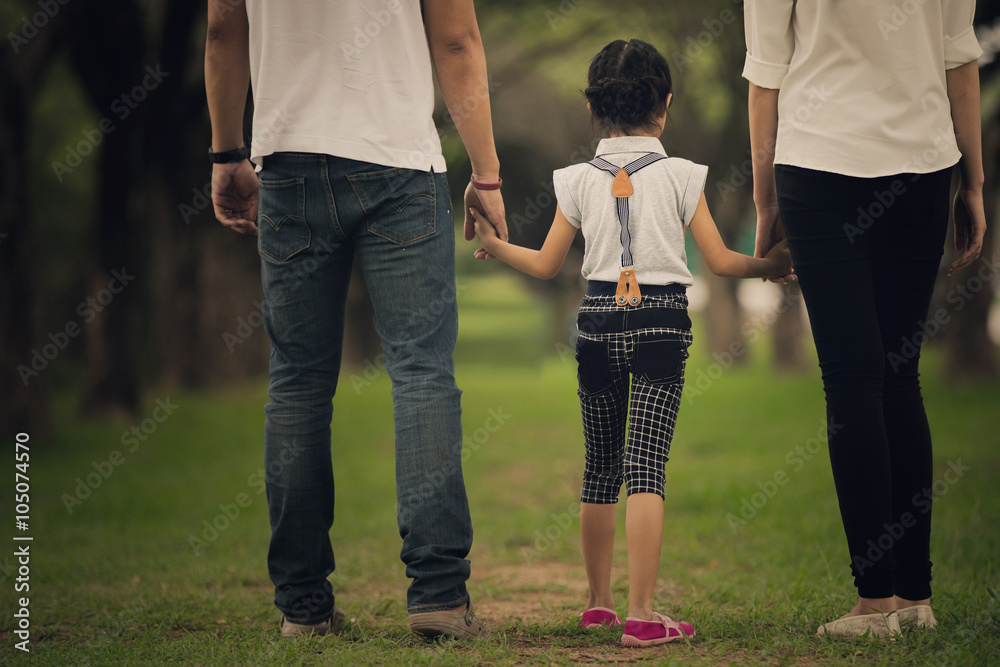 Daughters, parents were holding hands in the park