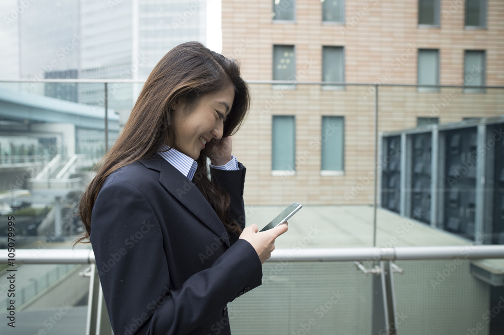 Women wearing the suit using a smartphone