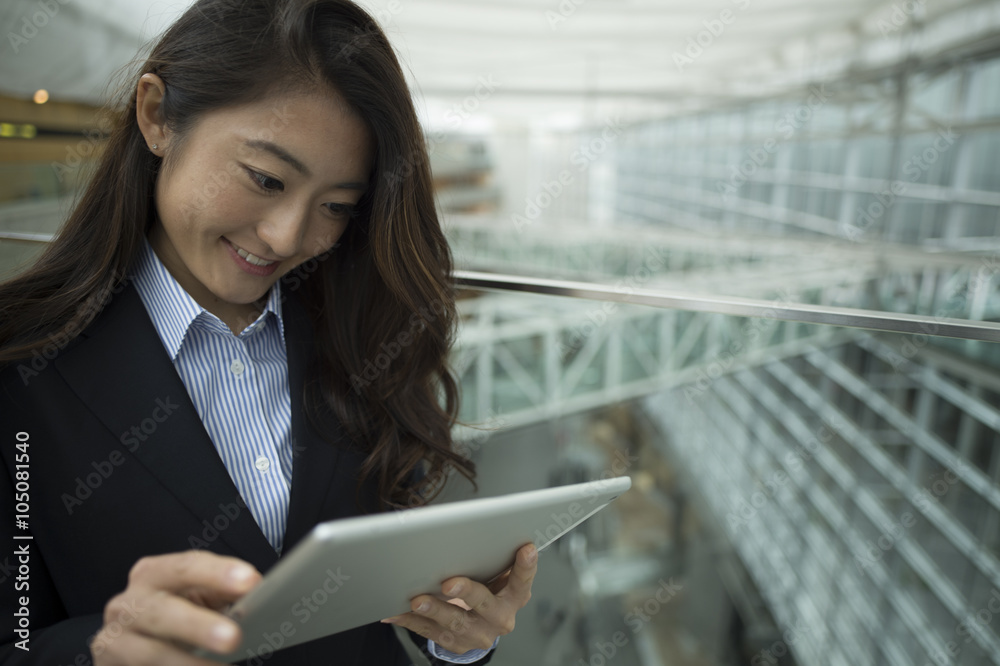 Women touch the tablet in the modern office