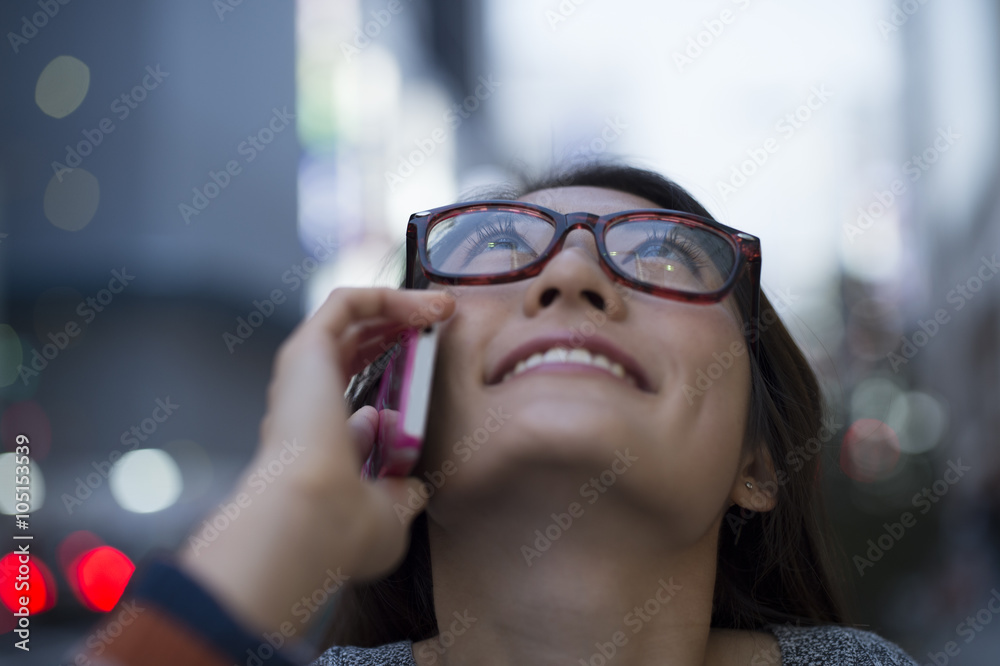 年轻女性在仰望天空时打电话