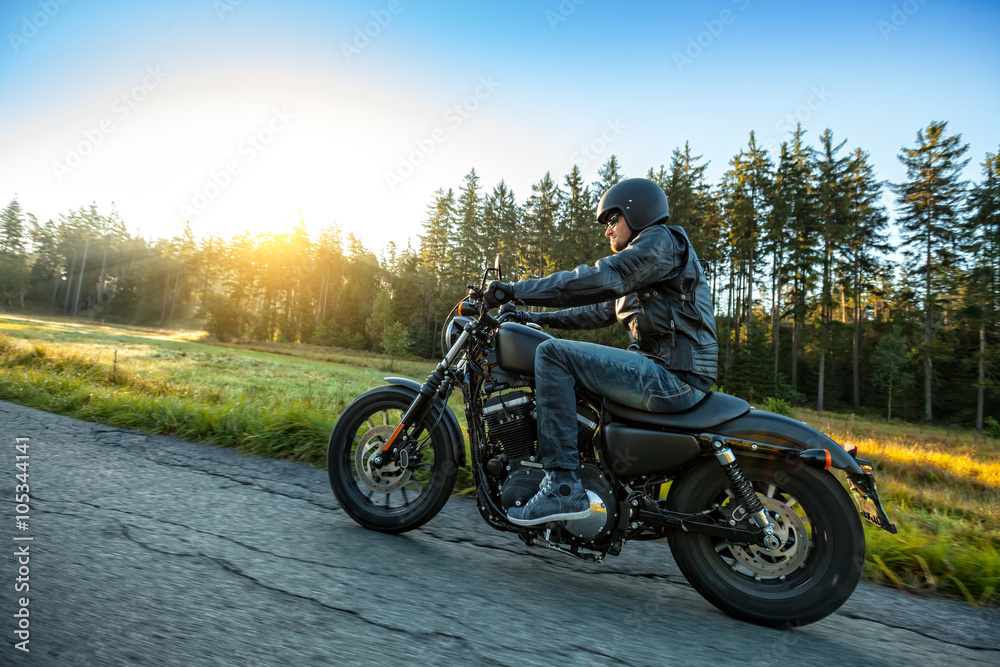 Motorcyclist riding  chopper on a road