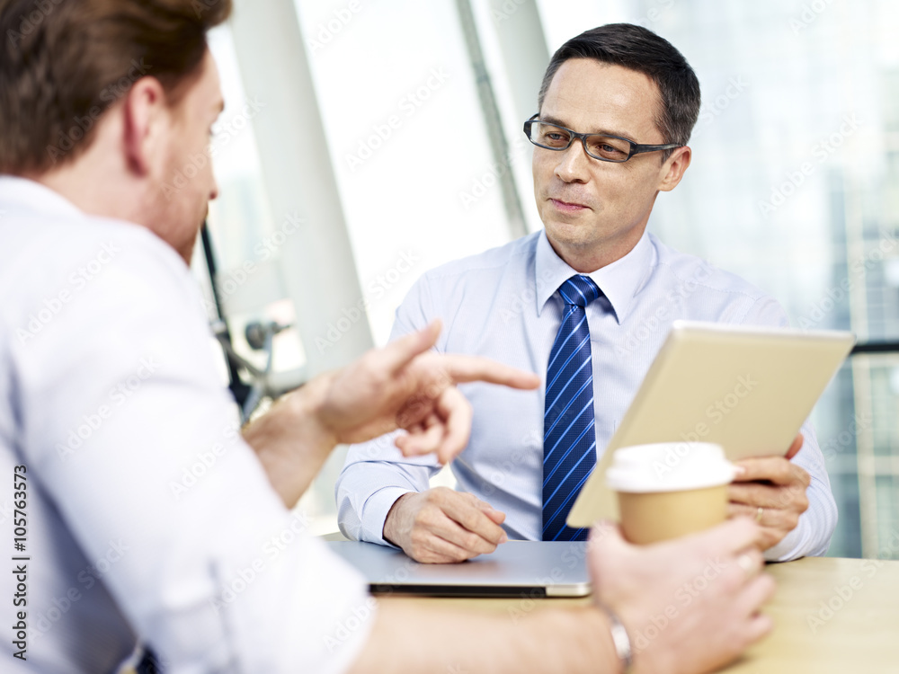 businesspeople discussing business in office