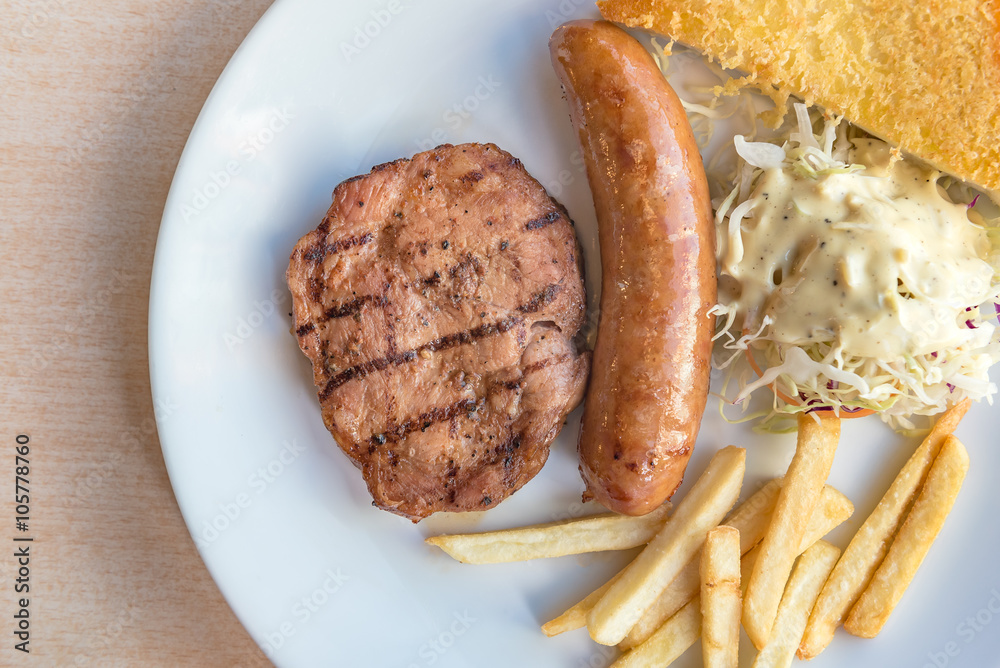 Grilled steak, French fries and vegetables