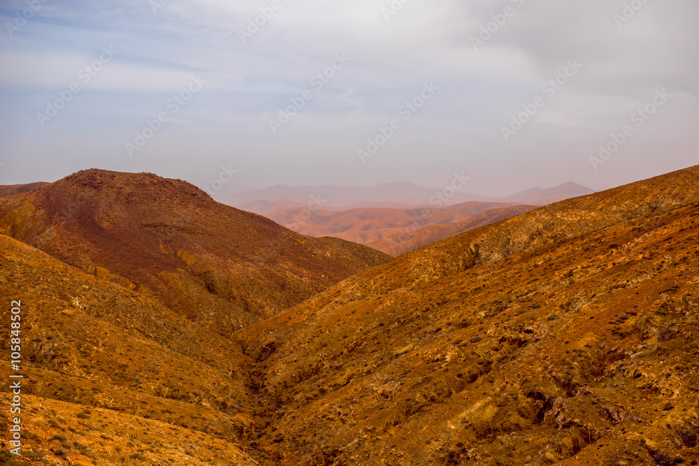 Mountain landscape at the central part of Fuerteventura island on the cloudy and foggy weather in Sp